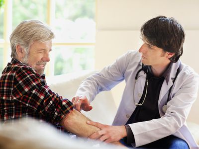 Doctor examining senior man