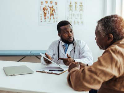 A person consults their healthcare provider in a medical office