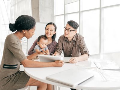 Couple with a baby filling out health insurance paperwork