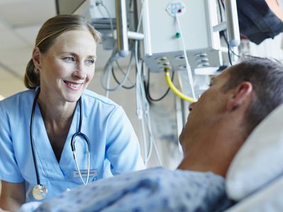 A doctor and a patient in a hospital ward.