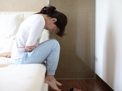 A woman experiences abdominal pain from IBS