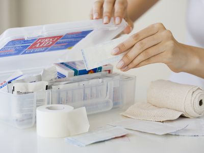 Woman packing first aid kit