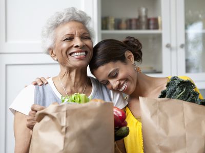 Older mother and adult daughter with shopping bags of food, food subsidies for Medicare/Medicaid