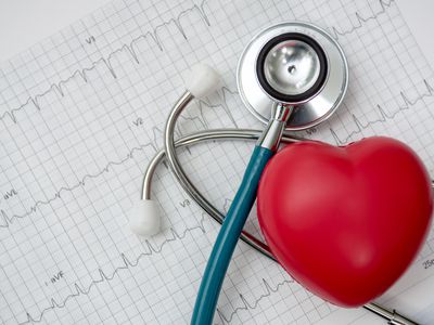 Red heart shown beside a stethoscope and EKG chart.