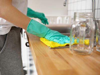 cleaning kitchen counter wearing gloves