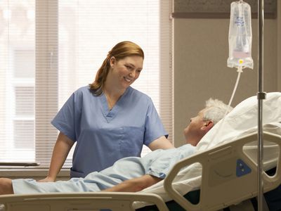 Female nurse with male patient in hospital