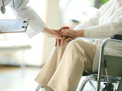 Doctor examining patient in wheelchair 