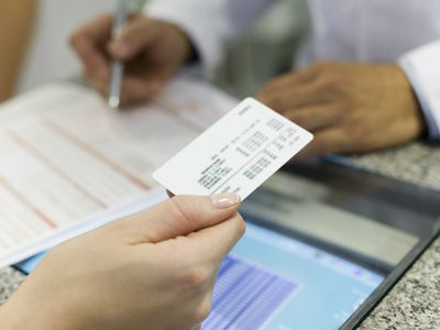 woman handing over helath insurance card