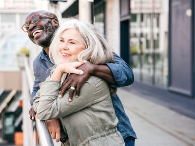 Middle-aged man and woman smiling and laughing