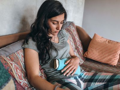 woman using hot water bottle