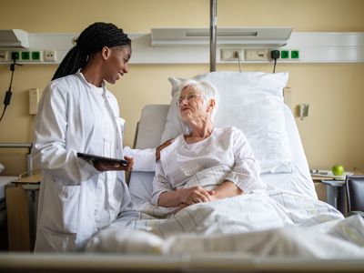 Elderly woman being visitied by nurse