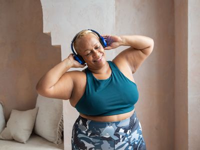 woman listening to music in workout clothes