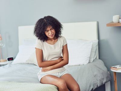 Person experiencing abdominal pain from IBS