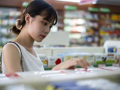 Woman looking at drugs in pharmacy