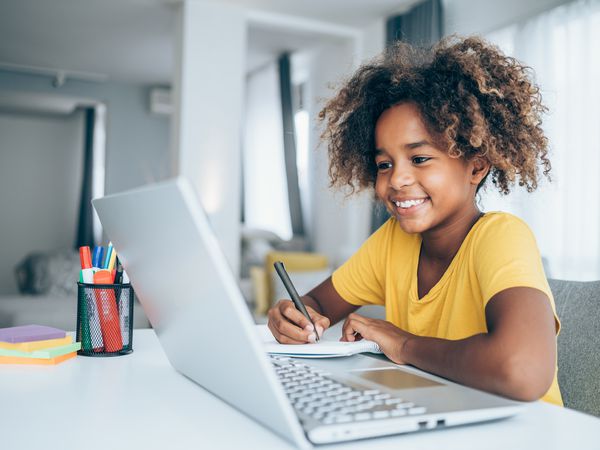 Schoolgirl studying with video online lesson at home