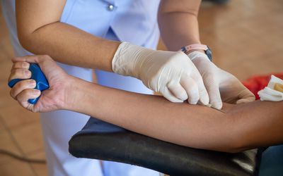 Nurse taking blood from patient