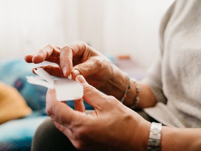 Close up shot of an older woman organizing medications.