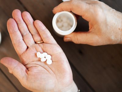 close-up of woman holding pills in her hand