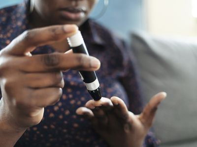 Person taking sample for blood glucose test for type 2 diabetes