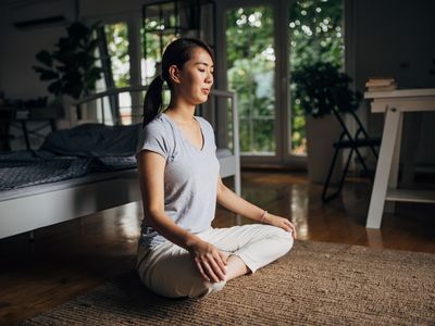 woman practicing yoga at home