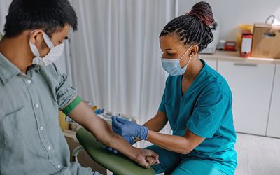 Nurse preparing patient to do a blood analysis - stock photo