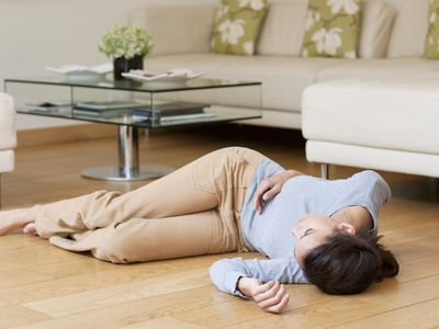 Woman lying on floor after fainting