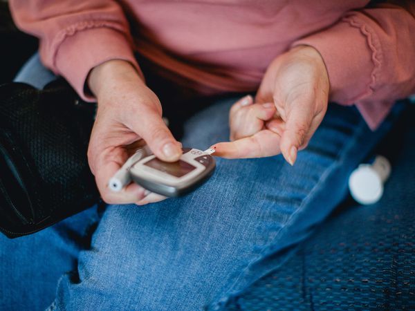 closeup of woman checking her blood sugar