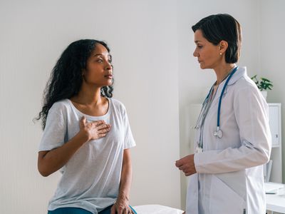 Woman talking to doctor about chest pain