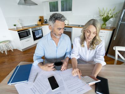 Older couple looking at bills on a table