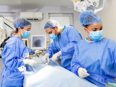 A surgical team performing surgery on a patient in an operating room