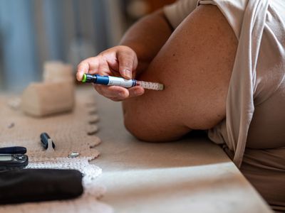 Person injecting themselves with insulin