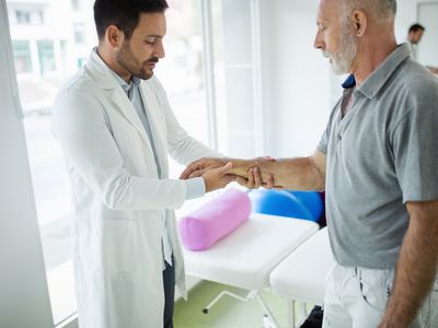 Healthcare provider examining a man's wrist