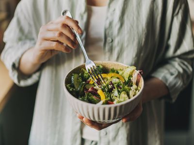 close-up of woman holding a salad