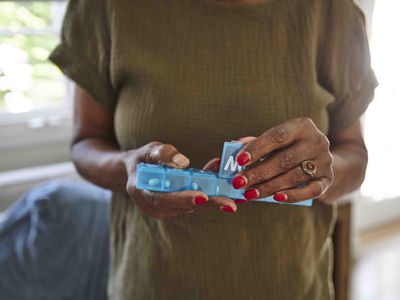 Woman holding pill box