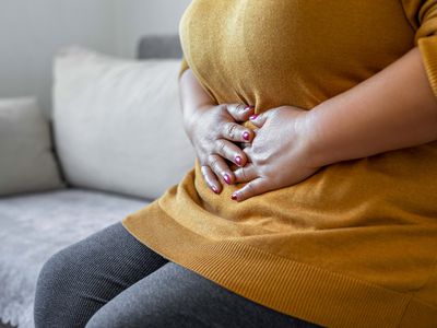 woman touching midsection