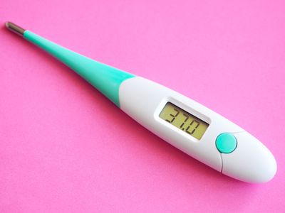 A white and teal thermometer that reads "37.0" on a bright pink background.