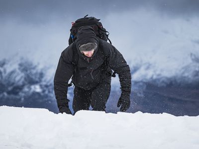 Man hiking snowy mountain