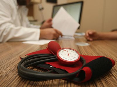 A blood pressure cuff on a desk in a provider's office.