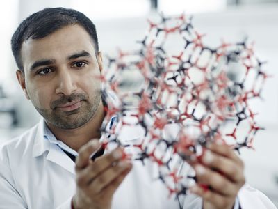 Researcher holding a model of a chemical molecule