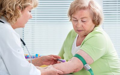 Nurse taking blood sample