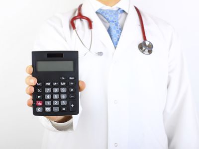 Doctor holding a calculator.