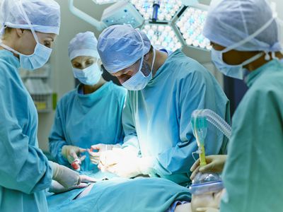 Surgeons performing surgery in operating room