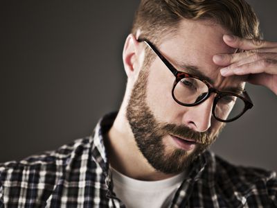 Stressed man with head in hands