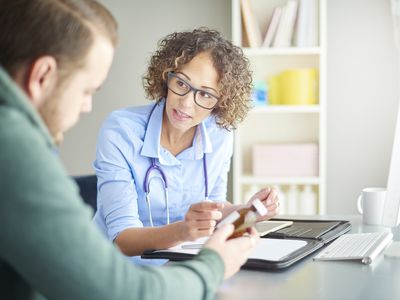 Doctor giving patient prescription drugs