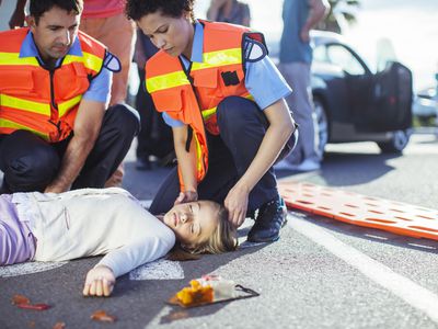 first responders checking unconscious girl