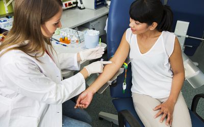 Doctor administering blood test