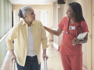 A clinical nurse specialist talks to a woman in a rehabilitation center