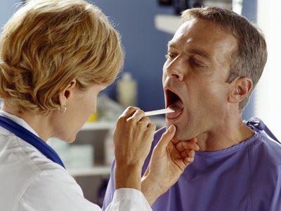 Doctor Examining Patient's Throat