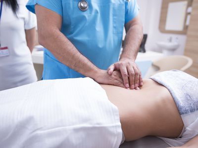 A doctor checking a patients spleen