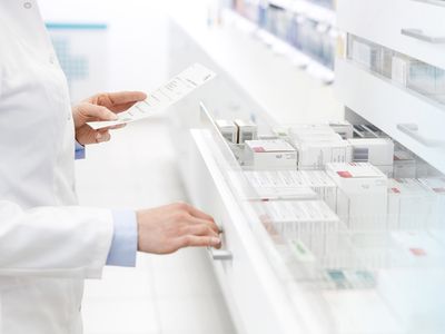 Pharmacist filling prescription in pharmacy